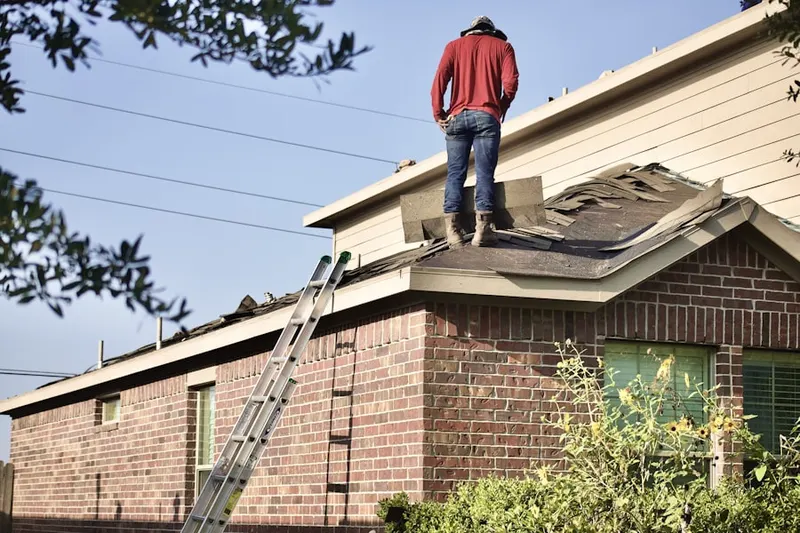 Professional roofer working on a residential roof in Round Lake Park